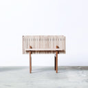 Squarely Self-Watering planter GrowWIDE in natural ash wood standing on concrete floor
