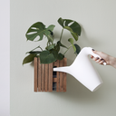 GrowON Dark Oak with Self-Watering-System with green plant hanging on the wall getting water