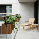 Modern balcony with wooden planters and furniture